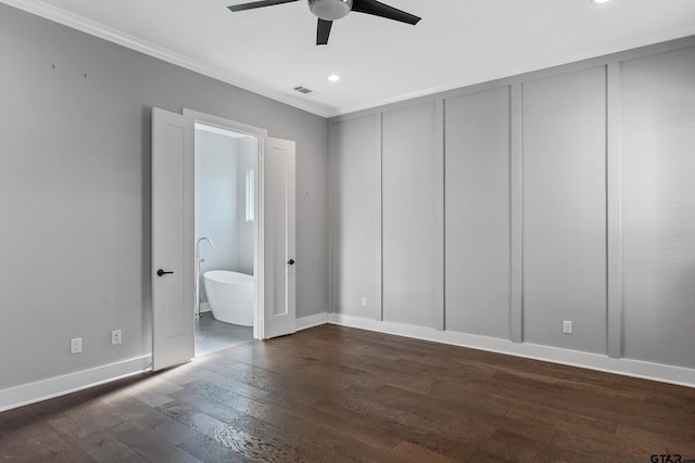 unfurnished bedroom featuring ensuite bath, ceiling fan, dark hardwood / wood-style flooring, and crown molding