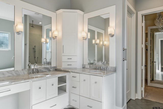 bathroom featuring tile patterned flooring, vanity, and walk in shower