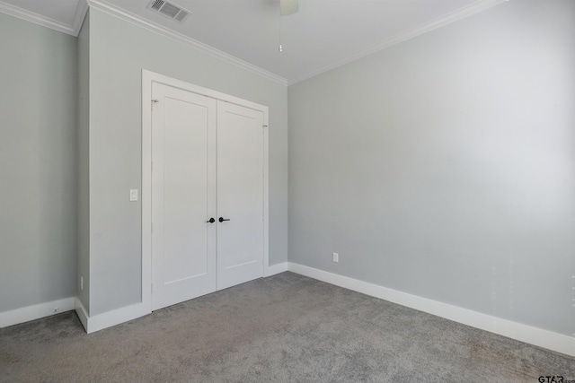 unfurnished bedroom with light carpet, a closet, ceiling fan, and crown molding