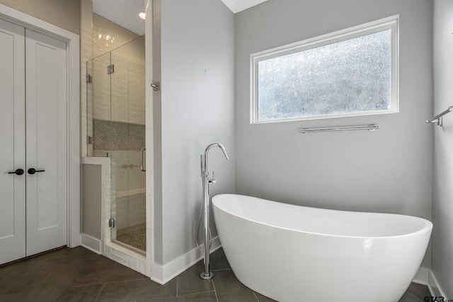 bathroom with shower with separate bathtub and tile patterned floors