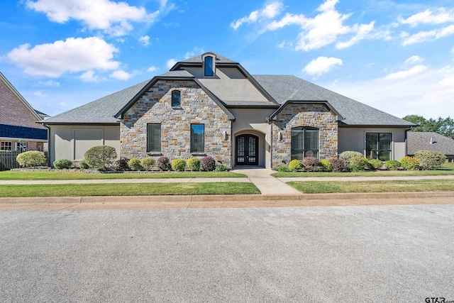 french country inspired facade featuring french doors