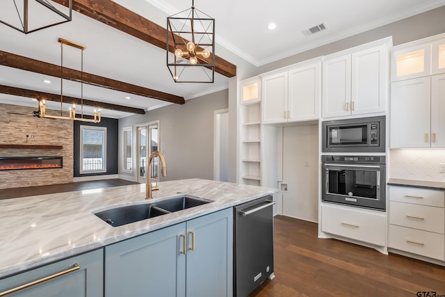 kitchen with white cabinetry, sink, hanging light fixtures, and appliances with stainless steel finishes