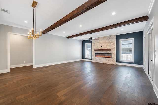 unfurnished living room with a healthy amount of sunlight, dark hardwood / wood-style flooring, and beam ceiling