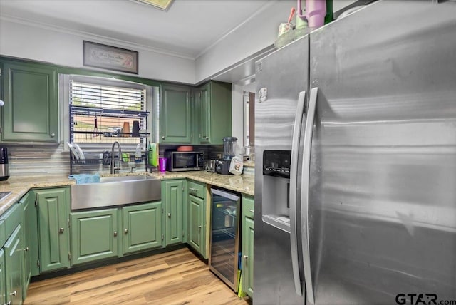 2631 Amy Ln, Tyler, TX 75701 - kitchen with appliances with stainless steel finishes, beverage cooler, crown molding, decorative backsplash, and green cabinetry
