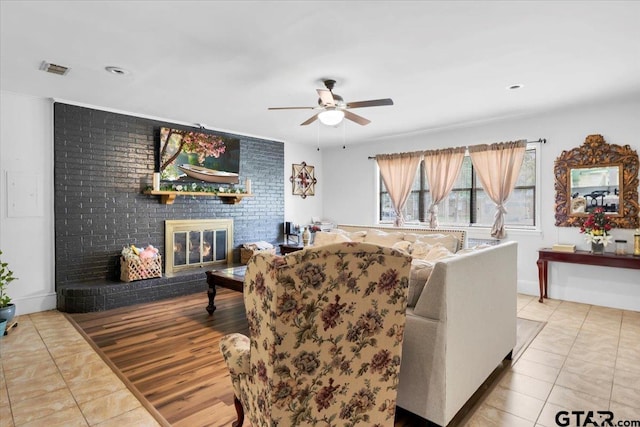 2631 Amy Ln, Tyler, TX 75701 - tiled living area with ceiling fan and a brick fireplace