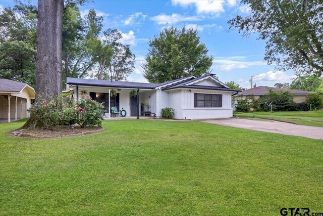 2631 Amy Ln, Tyler, TX 75701 - single story home with a front lawn and board and batten siding