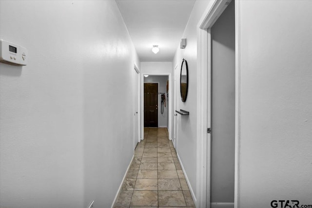 2631 Amy Ln, Tyler, TX 75701 - hall with baseboards and stone tile floors