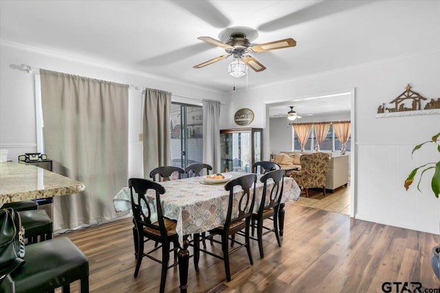 2631 Amy Ln, Tyler, TX 75701 - dining space featuring ceiling fan, crown molding, wood finished floors, and a wainscoted wall