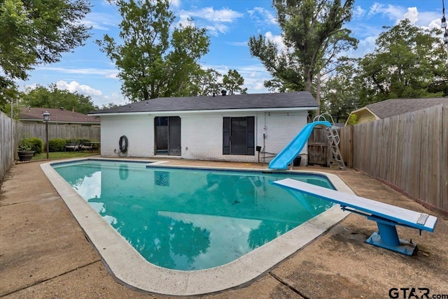 2631 Amy Ln, Tyler, TX 75701 - view of swimming pool with a water slide, a diving board, and a fenced backyard