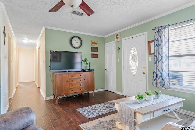 entryway with ornamental molding, dark wood-type flooring, a textured ceiling, and ceiling fan