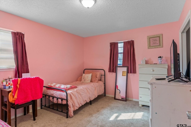 carpeted bedroom featuring a textured ceiling