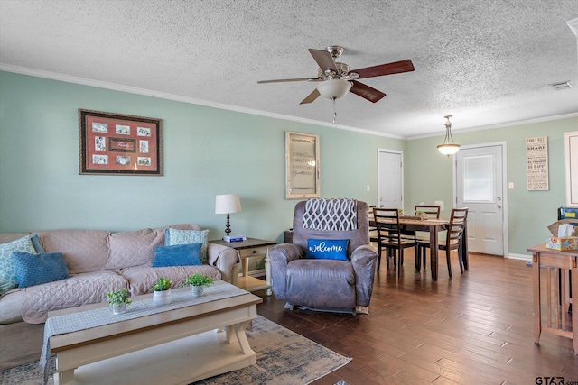 living room with ceiling fan, ornamental molding, dark hardwood / wood-style flooring, and a textured ceiling