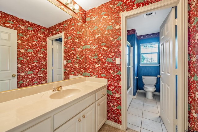 full bathroom with baseboards, enclosed tub / shower combo, toilet, tile patterned floors, and vanity