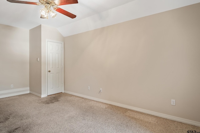 unfurnished room featuring a ceiling fan, lofted ceiling, light colored carpet, and baseboards