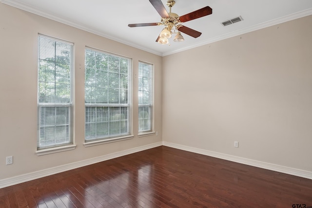 spare room featuring dark wood-style floors, visible vents, a ceiling fan, and baseboards