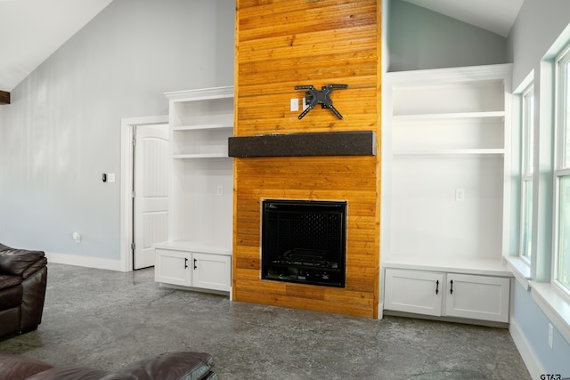 1605 County Road 4510, Winnsboro, TX 75494 - unfurnished living room featuring vaulted ceiling, plenty of natural light, baseboards, and a fireplace