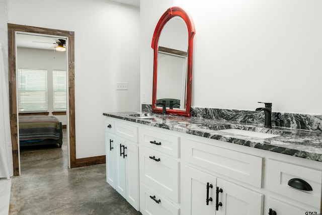 1605 County Road 4510, Winnsboro, TX 75494 - bathroom featuring concrete flooring, a ceiling fan, double vanity, baseboards, and ensuite bath