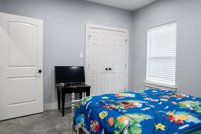 1605 County Road 4510, Winnsboro, TX 75494 - bedroom with a closet, concrete floors, and baseboards
