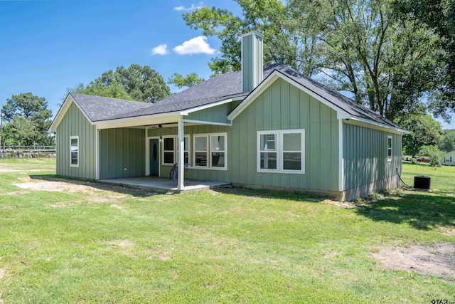 1605 County Road 4510, Winnsboro, TX 75494 - rear view of house with board and batten siding, roof with shingles, a patio area, central AC unit, and a yard