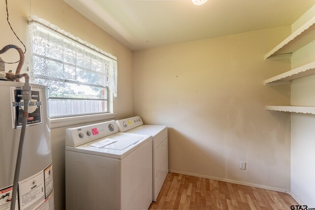 138 Drexel Dr, Sulphur Springs, TX 75482 - laundry area with gas water heater, separate washer and dryer, light wood-type flooring, and baseboards