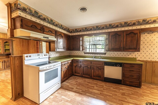 138 Drexel Dr, Sulphur Springs, TX 75482 - kitchen with white electric stove, dishwasher, under cabinet range hood, a sink, and wood walls
