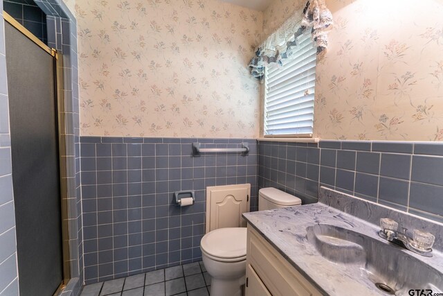 138 Drexel Dr, Sulphur Springs, TX 75482 - bathroom with a wainscoted wall, toilet, a stall shower, vanity, and tile patterned flooring