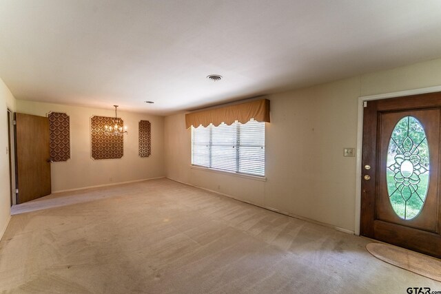 138 Drexel Dr, Sulphur Springs, TX 75482 - entryway with a chandelier, plenty of natural light, light colored carpet, and baseboards