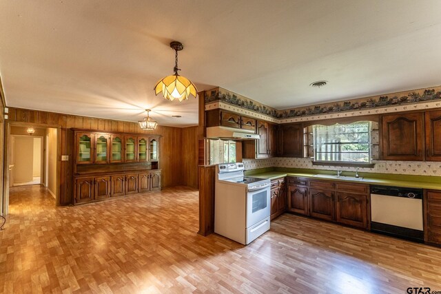 138 Drexel Dr, Sulphur Springs, TX 75482 - kitchen featuring white appliances, a sink, under cabinet range hood, light wood-style flooring, and wood walls