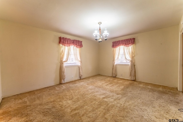138 Drexel Dr, Sulphur Springs, TX 75482 - carpeted empty room with plenty of natural light and a chandelier