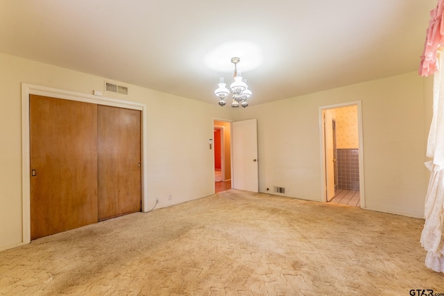 138 Drexel Dr, Sulphur Springs, TX 75482 - unfurnished bedroom with a chandelier, carpet floors, a closet, and connected bathroom