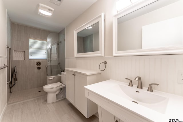 138 Drexel Dr, Sulphur Springs, TX 75482 - bathroom with a walk in shower, toilet, a sink, and wainscoting