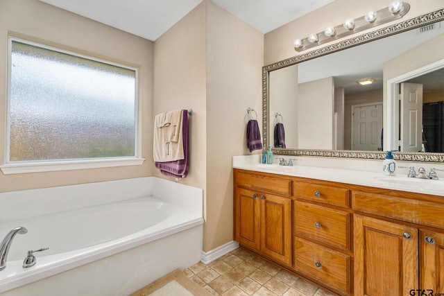 bathroom with vanity and a tub