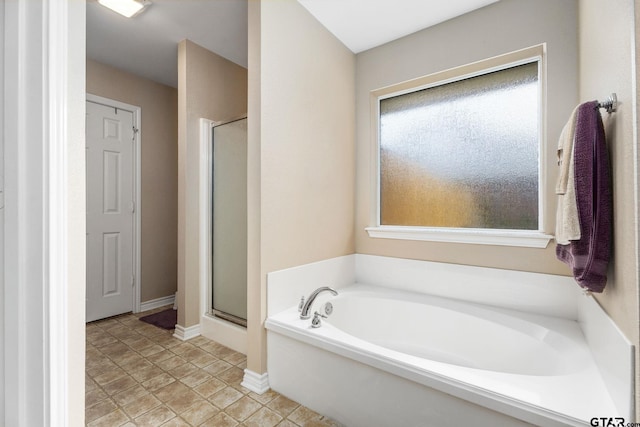 bathroom featuring separate shower and tub