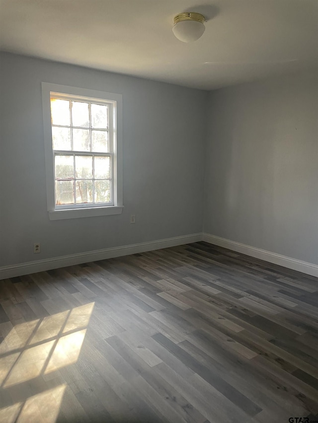 empty room with dark hardwood / wood-style floors