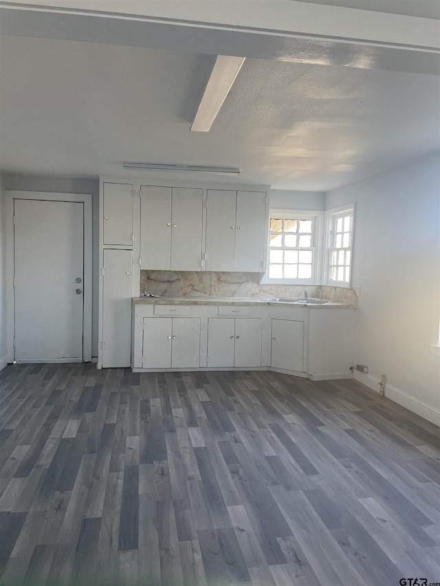 kitchen featuring decorative backsplash, white cabinets, and dark hardwood / wood-style floors