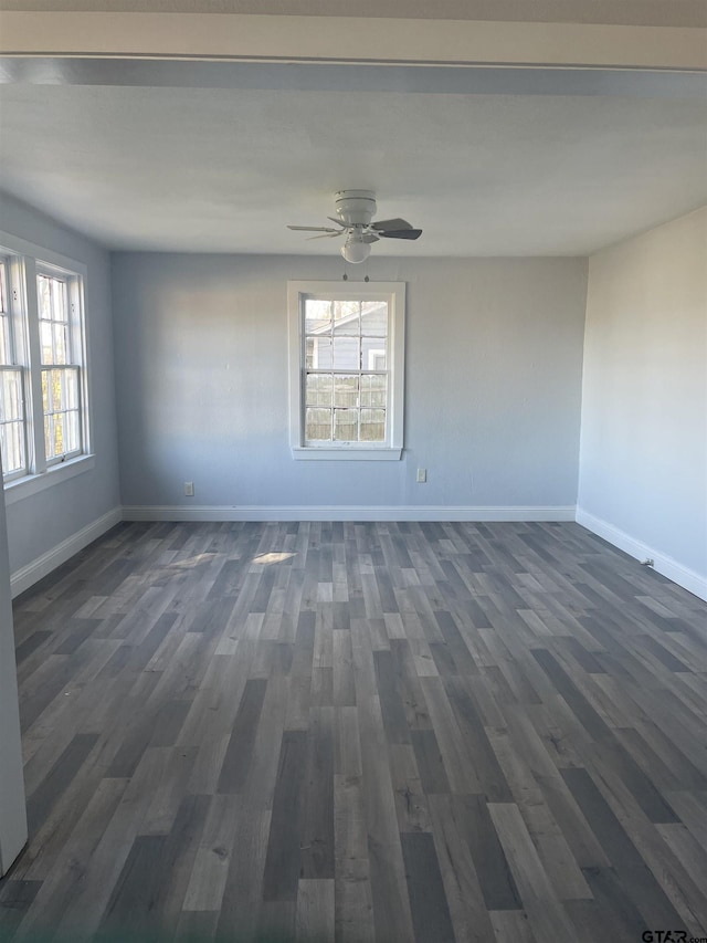 spare room with ceiling fan and dark hardwood / wood-style floors