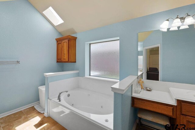 3029 Yasmeen Cir, Flint, TX 75762 - bathroom featuring a whirlpool tub, vanity, a skylight, and baseboards