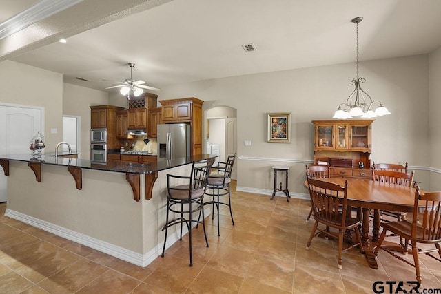 3029 Yasmeen Cir, Flint, TX 75762 - kitchen featuring stainless steel appliances, arched walkways, a ceiling fan, a breakfast bar, and a sink
