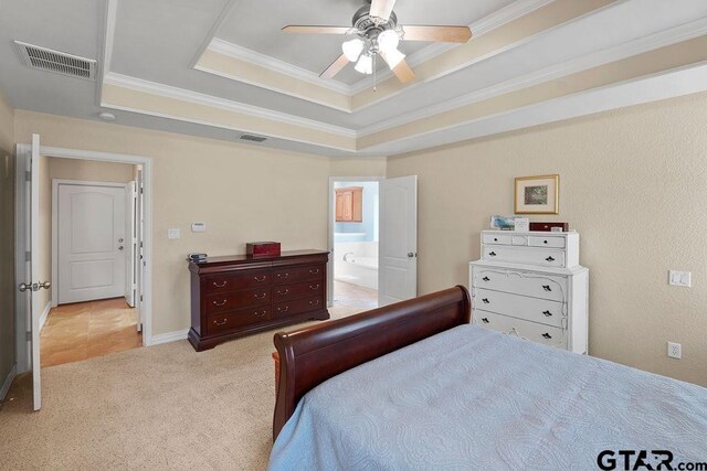 3029 Yasmeen Cir, Flint, TX 75762 - carpeted bedroom with a tray ceiling, crown molding, connected bathroom, and a ceiling fan