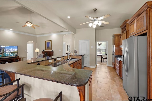 3029 Yasmeen Cir, Flint, TX 75762 - kitchen featuring stainless steel appliances, ceiling fan, arched walkways, brown cabinetry, and recessed lighting