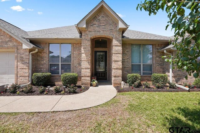 3029 Yasmeen Cir, Flint, TX 75762 - doorway to property with brick siding, a shingled roof, and a lawn