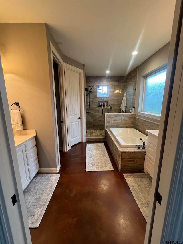 bathroom featuring vanity, concrete flooring, and shower with separate bathtub