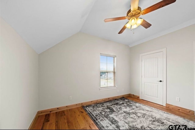 spare room with hardwood / wood-style floors, ceiling fan, and lofted ceiling