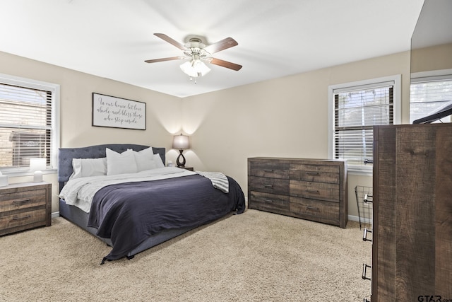 carpeted bedroom with ceiling fan and multiple windows