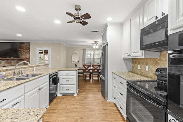 kitchen featuring kitchen peninsula, sink, white cabinets, and black appliances