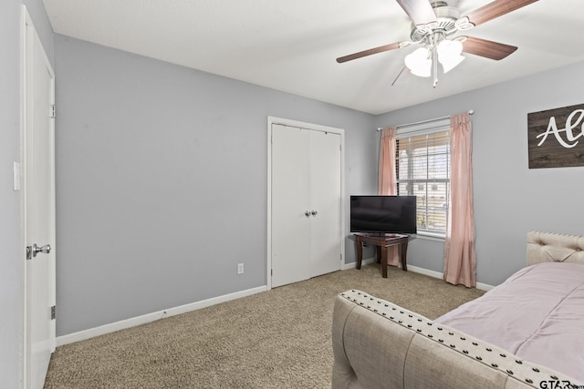 carpeted bedroom featuring ceiling fan and a closet