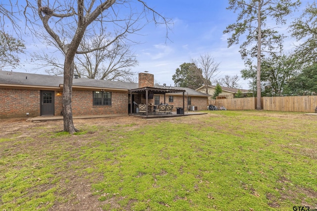 back of house featuring a lawn and a patio