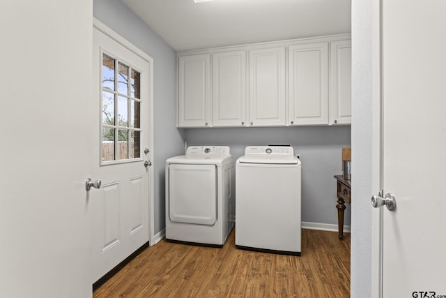 laundry room featuring cabinets, independent washer and dryer, and hardwood / wood-style flooring