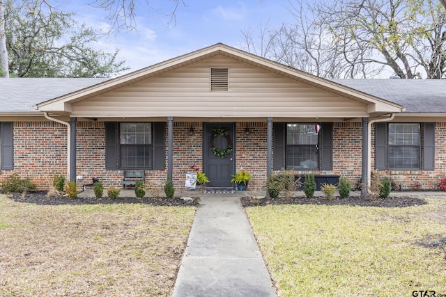 single story home with a front yard and a porch