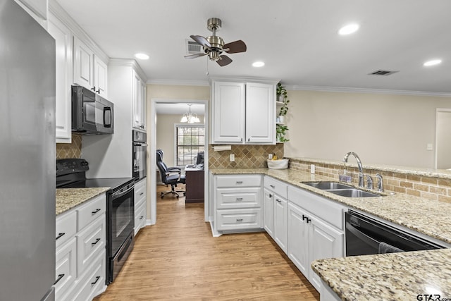 kitchen with black appliances, sink, crown molding, light wood-type flooring, and white cabinets